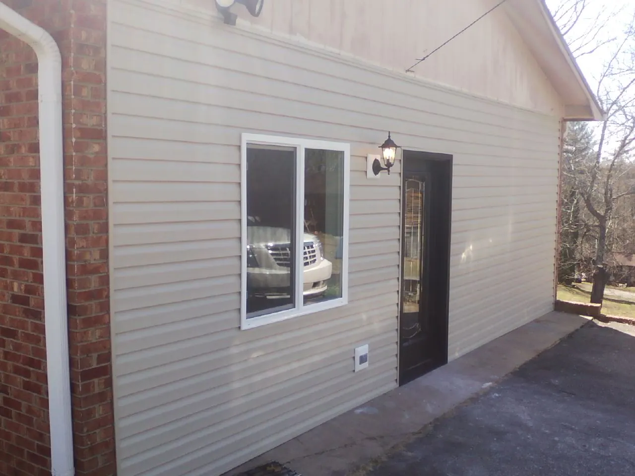 New vinyl siding and entry door on a room addition in Reinholds